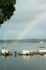 Rainbow over a body of water and boats.